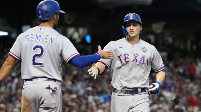 Rangers' Corey Seager, right, celebrates with Marcus Semien after both scored on Seager's home run in Game 4 of the 2023 World Series
